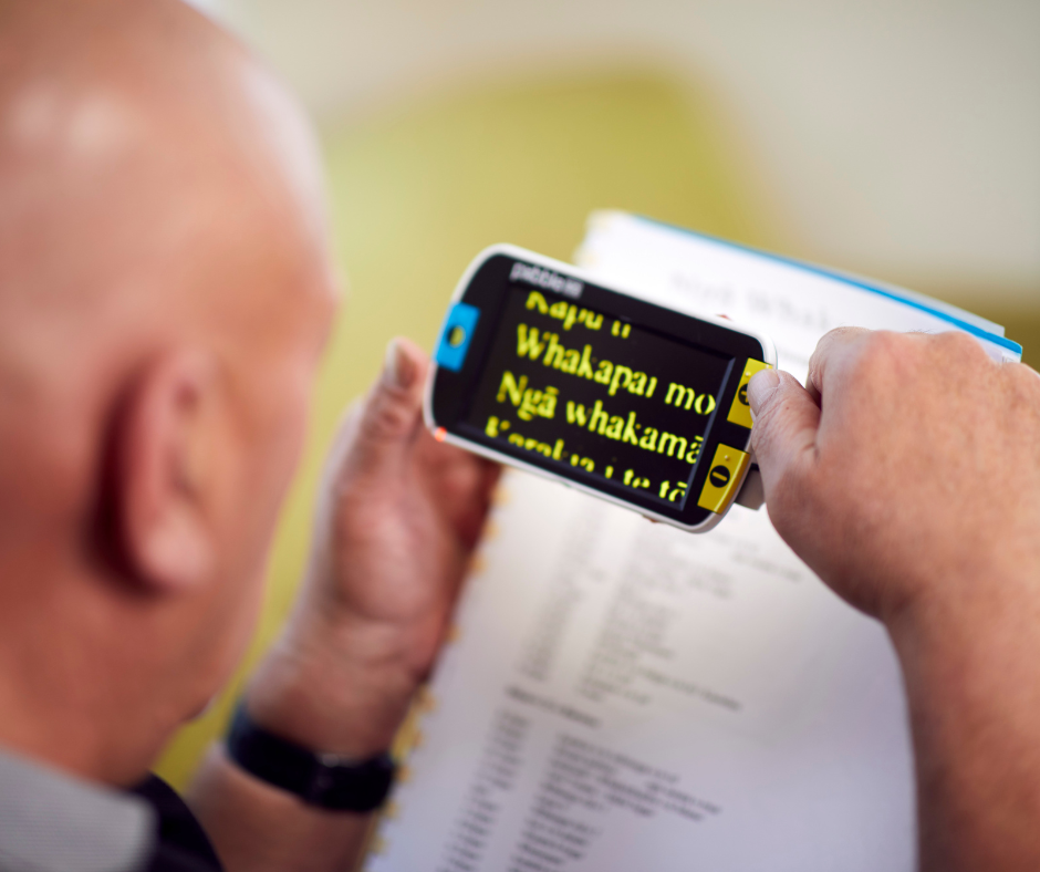 A man using assistive technology to read a book. A man using assistive technology to read a book.