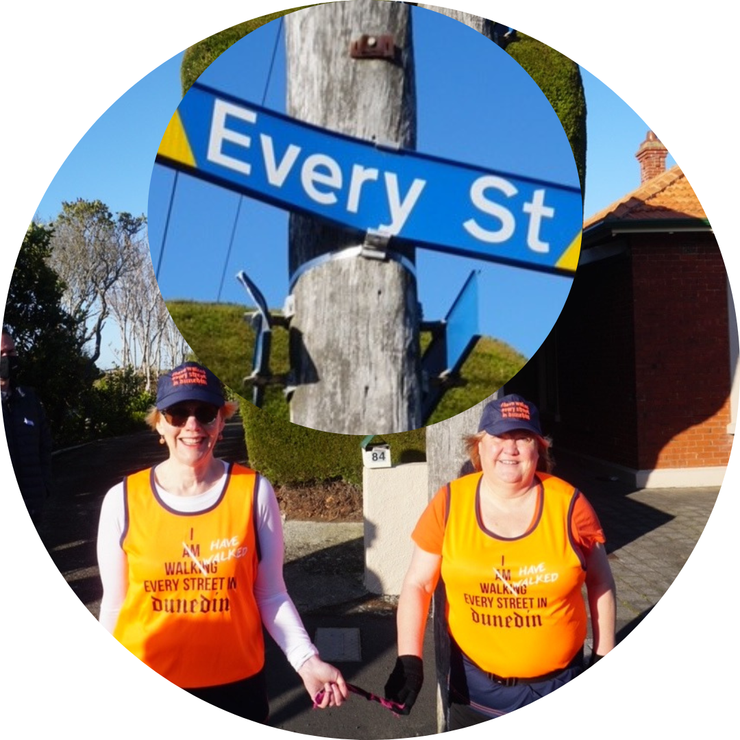 Julie Woods aka That Blind Woman, with her sighted guide Jo Stodart, standing under the Every Street sign in Dunedin.